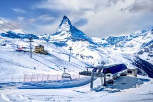 Zermatt Ski Resort surrounded by majestic snow-capped peaks, offering premier slopes and stunning alpine views
